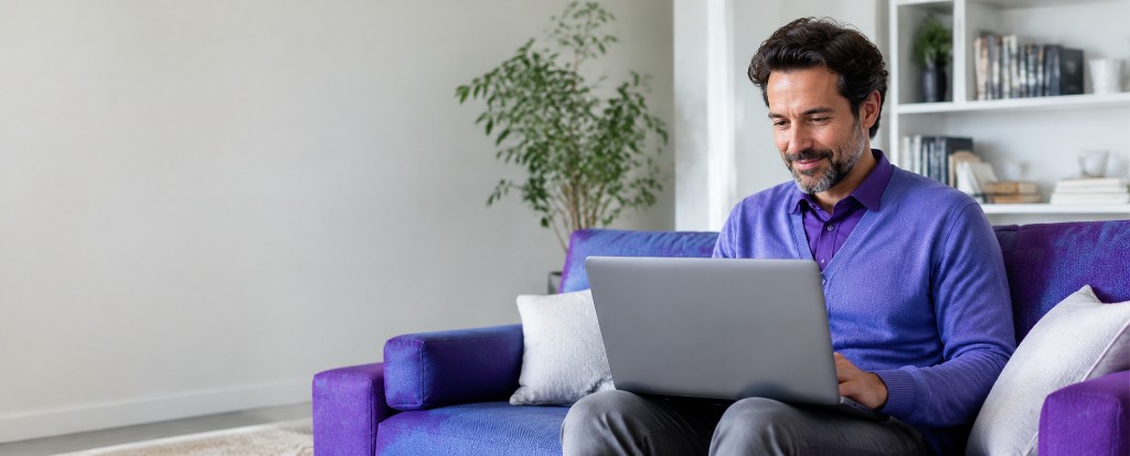 Man reviewing his finances on a laptop at home